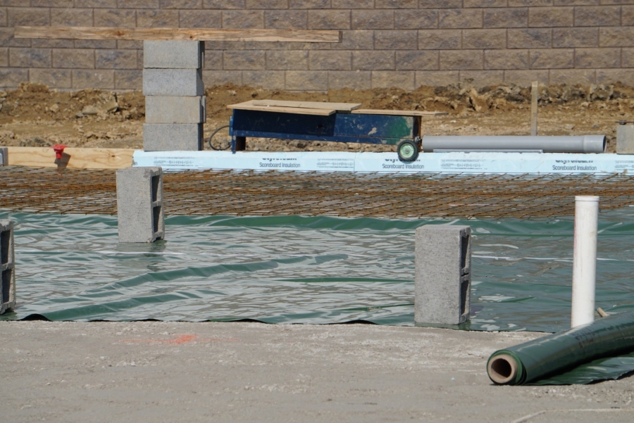 blue plastic sheets cover a foundation